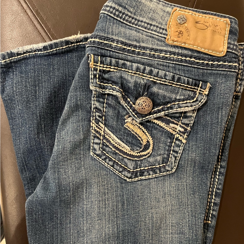 Silver Jeans Co. low-rise, boot cut with embellished pockets